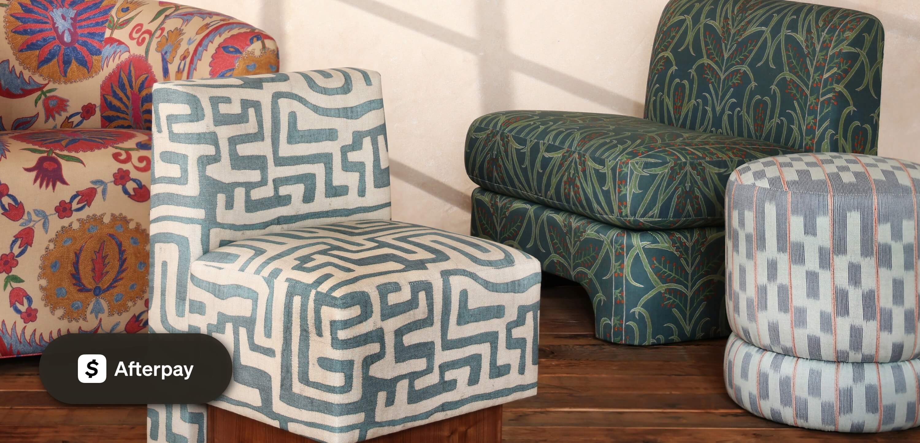 Sunlit room with St. Frank chairs and ottomans in bold global-inspired prints, styled with an Afterpay payment badge