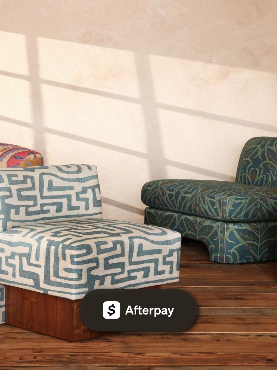 Sunlit room with St. Frank chairs and ottomans in bold global-inspired prints, styled with an Afterpay payment badge